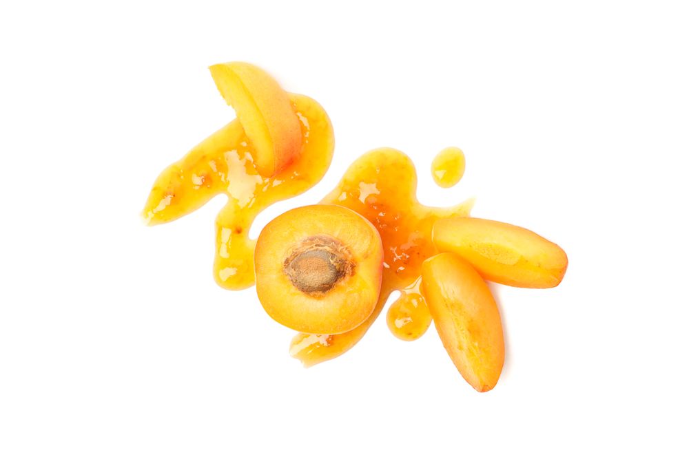Delicious apricot jam isolated on plain background