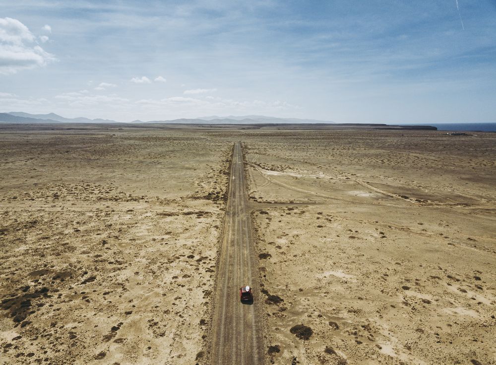 Car driving on road in picturesque desert