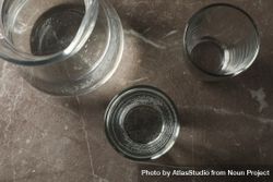 Top view of glasses of water and pitcher on grey marble table 4ADRq5