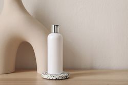 Single blank beauty bottle on wooden table