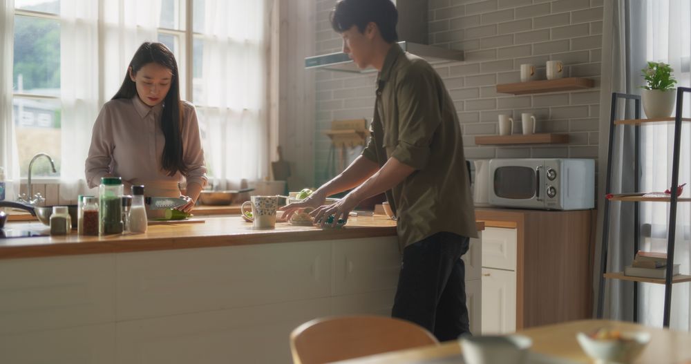 Portrait of a South Korean Young Couple Cooking at Home.