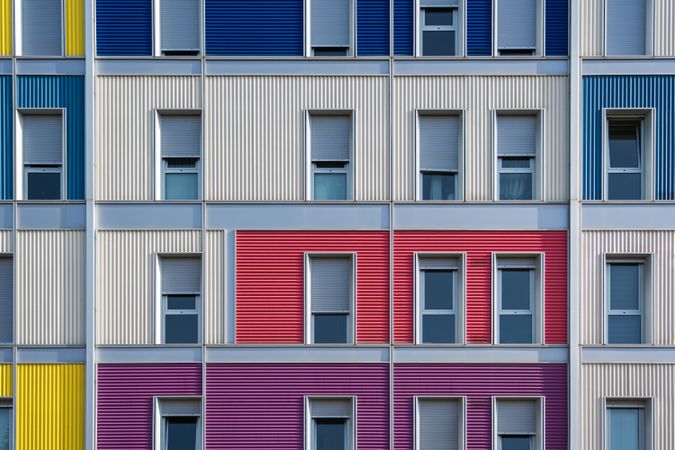 Facade of modern multicolored building with narrow windows