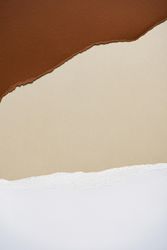 Earthy brown, beige and light torn paper background