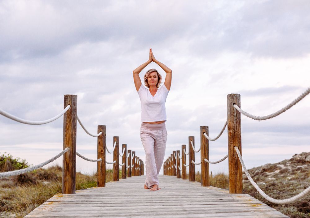 Cheerful woman exercising on timber path