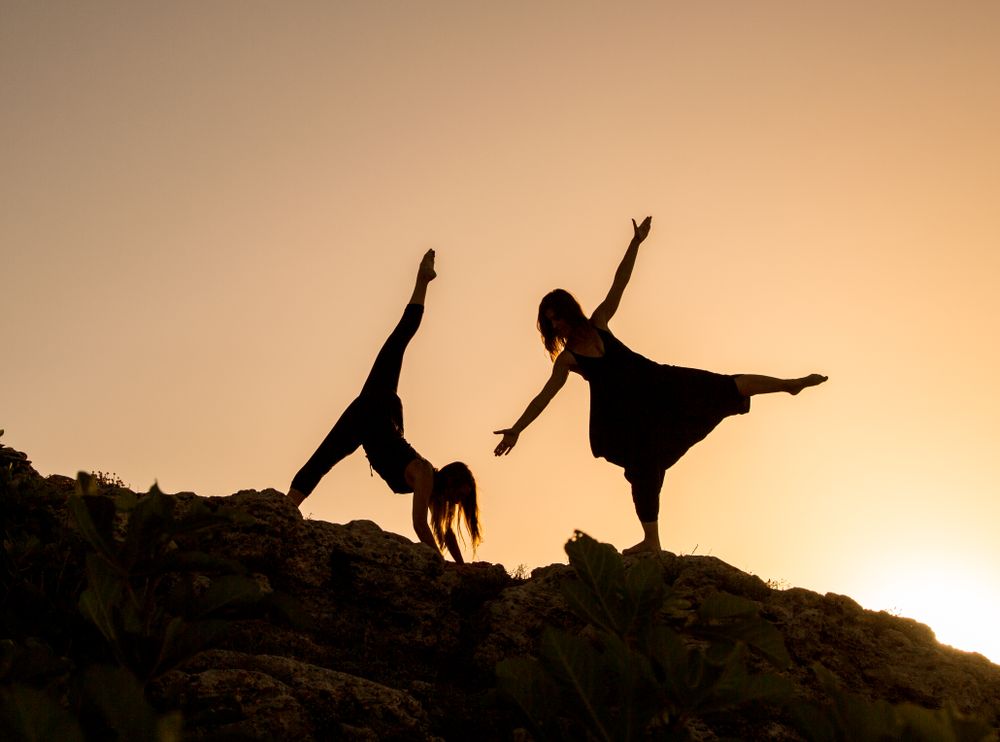 Women posing on hill in darkness