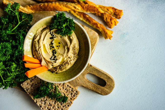 Traditional creamy hummus on kitchen counter with copy space