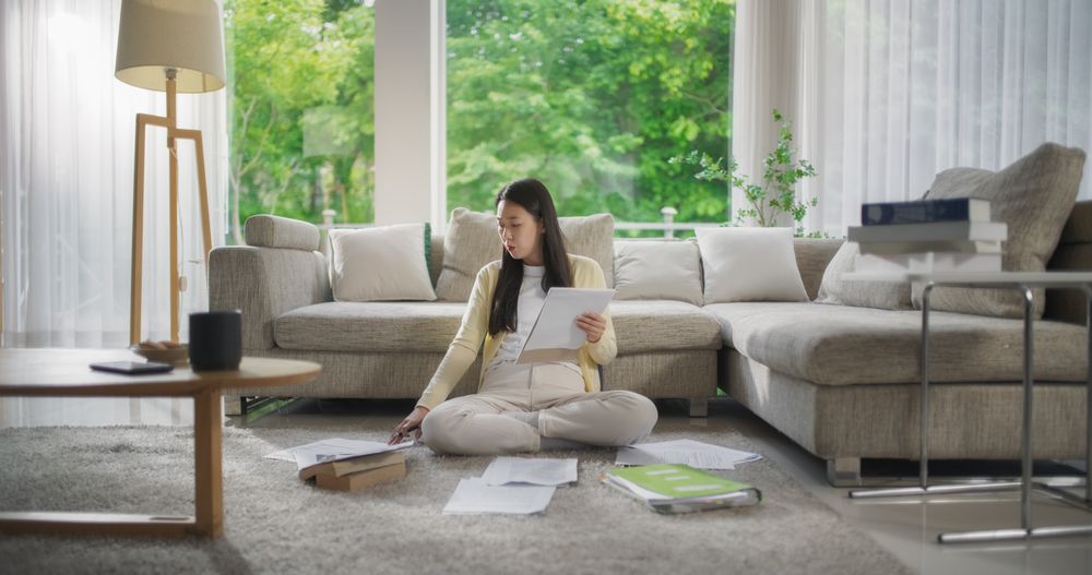 Young Asian Female Browsing Internet, Using Laptop Computer at Home