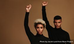 Couple with raised fists symbolizing fight against oppression 4BR3E4