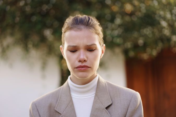 A Contemplative Woman Dressed in Neutral Tones and Captured in a ThoughtProvoking Atmosphere