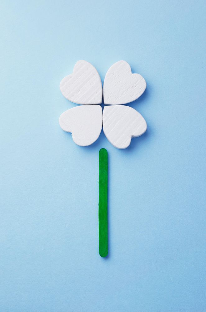 Hearts arranged as clover over light blue background