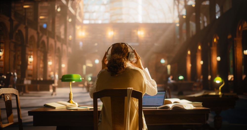 Young Woman Engaged in Online Education at a Classical Library