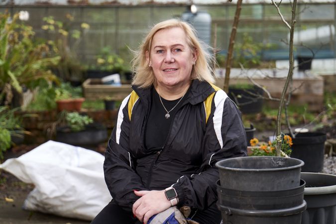 Woman smiling while sitting in garden