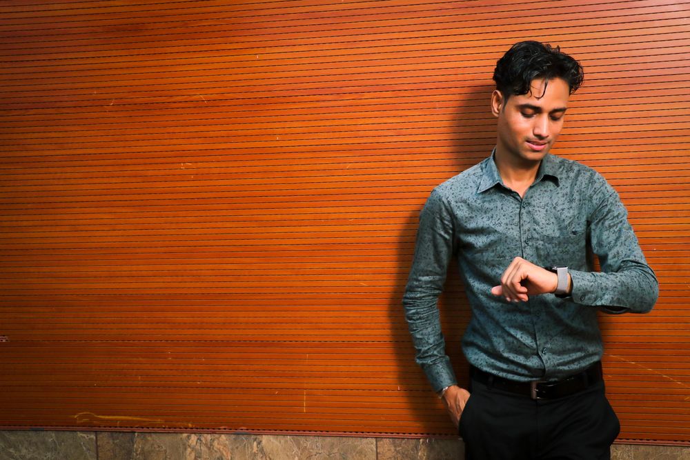 Young man looking at his watch