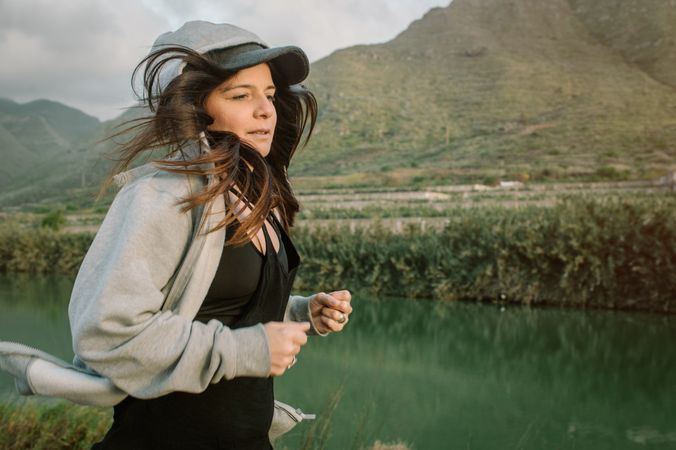 Positive woman running in park