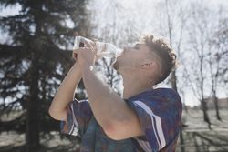 Young guy drinking water from bottle