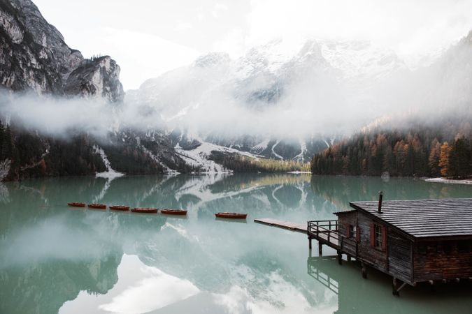 House on stilts on lake near mountains