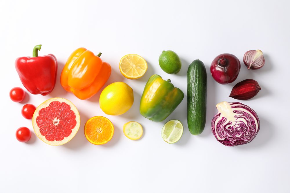 Flat lay with vegetables and fruits on plain background, copy space