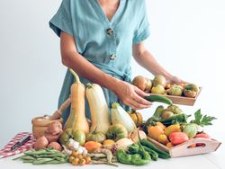 Woman with ripe fresh vegetables