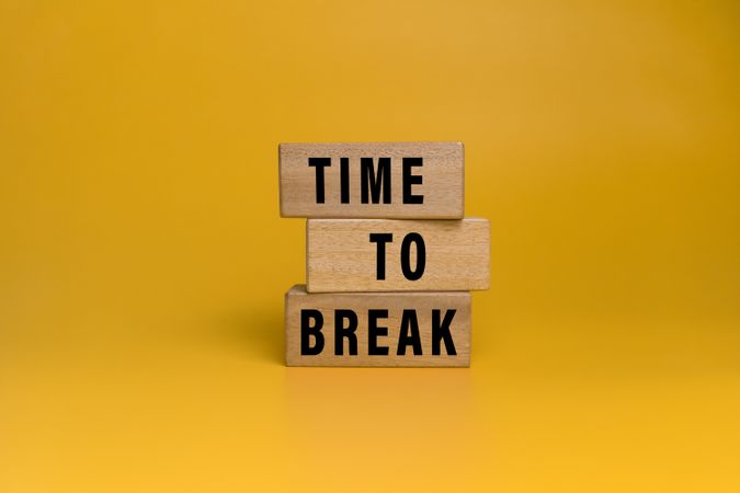 time to break words text on wooden blocks isolated on orange background