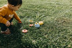 Toddler picking up his toys