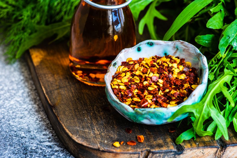 Fresh herbs with chili flakes and oil
