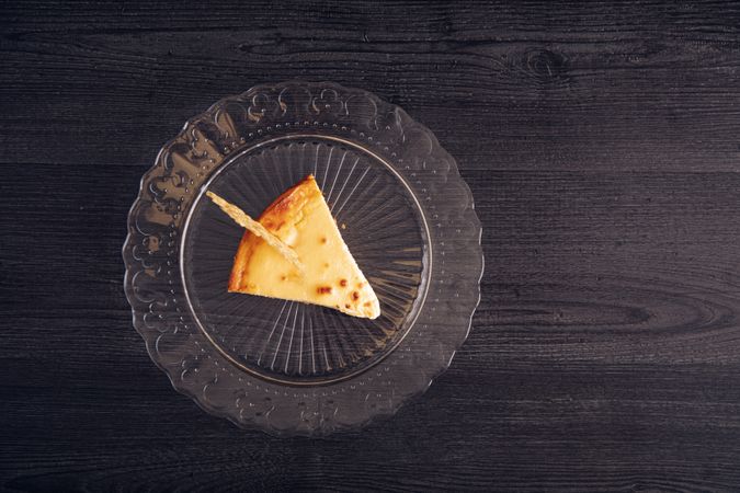 Baked cheesecake with red jam in glass plate