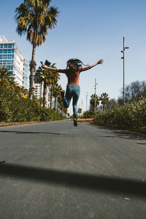 Teen girl walking happily through the streets.