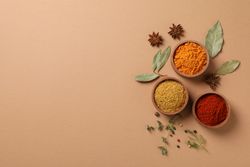 Top view of bowls of cumin and turmeric with copy space
