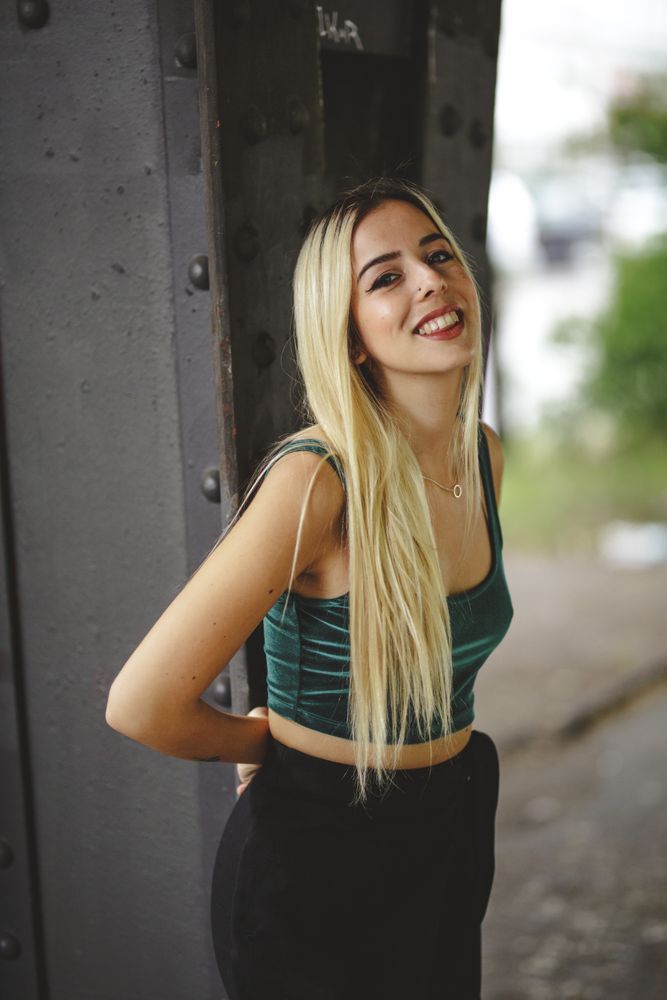 Blonde cheerful model standing and looking at camera