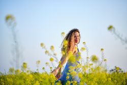 Carefree woman standing on verdant meadow in countryside