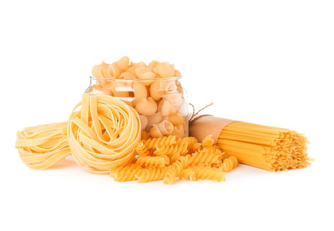 Pasta isolated on light background. Uncooked whole wheat pasta