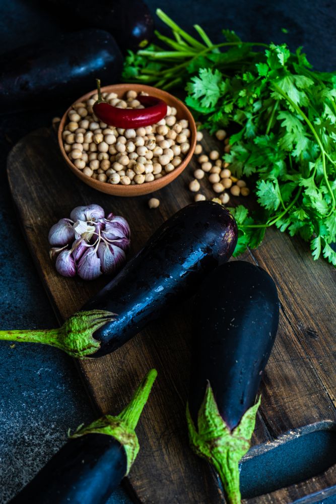 Eggplants and legumes on cutting board