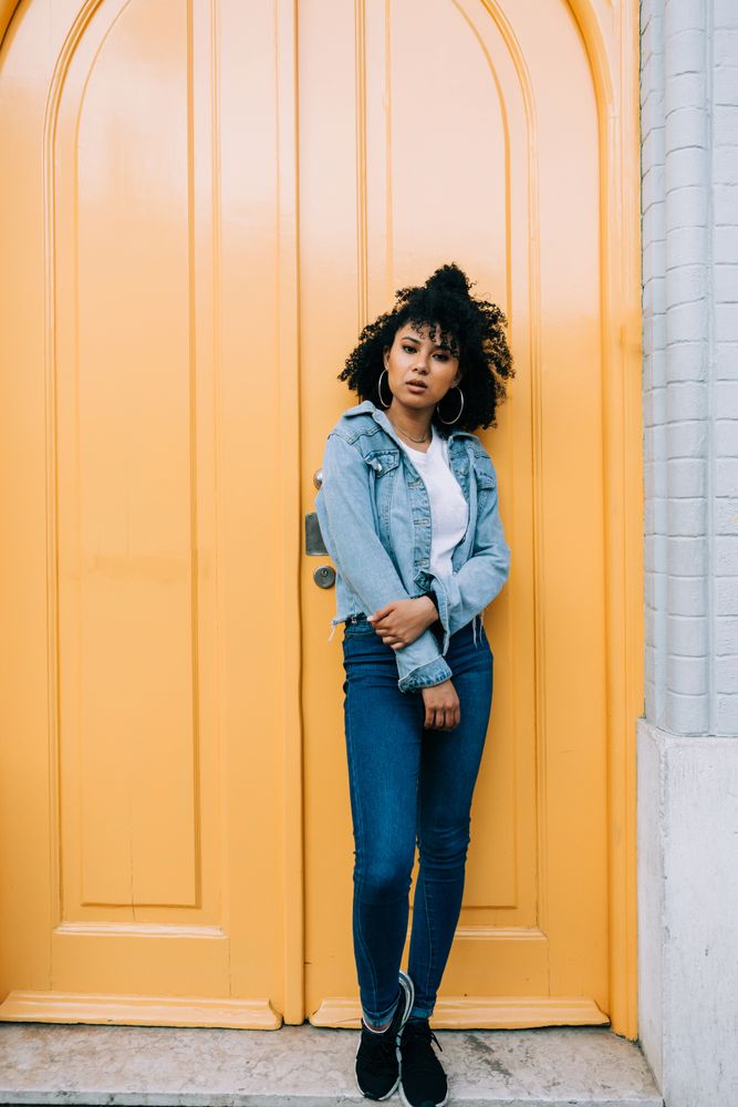 Stylish Black female by yellow door