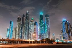 Cloudy sky over illuminated metropolis