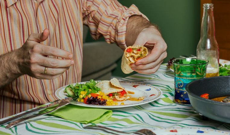 Man hands eating mexican food