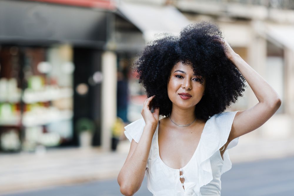 Black female looking at camera in urban background