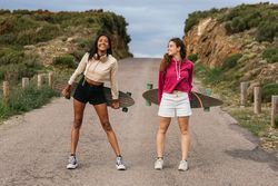 Cheerful diverse women standing on the road