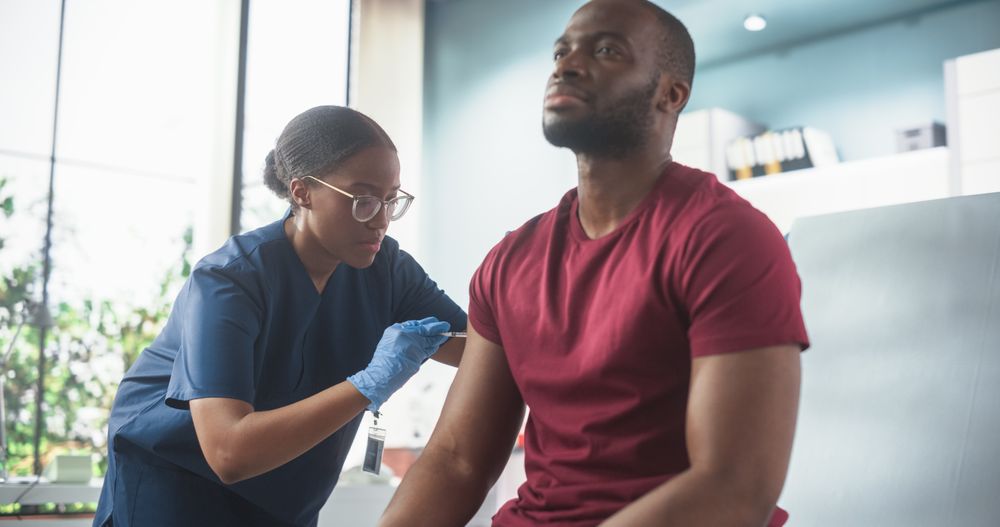 Professional Black Female Nurse Is Performing Injection And Putting A Patch On. Public Healthcare Concept