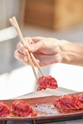 Unrecognizable person eating delicious gyoza