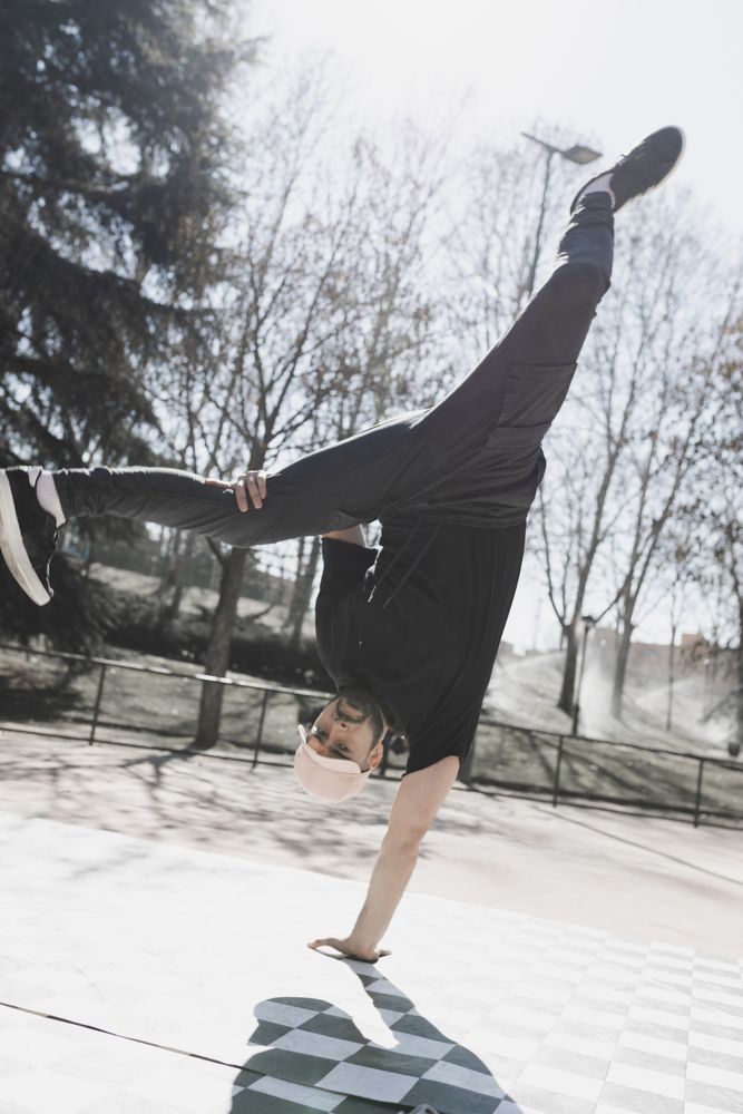 Man dancing break dance in park