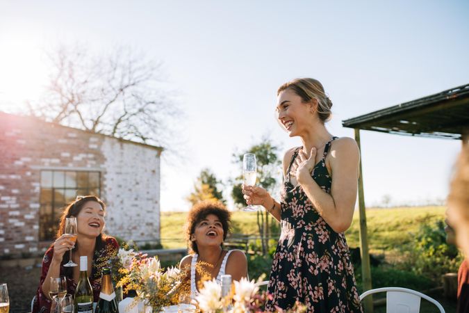 Grateful woman giving thanks to her friends for attending dinner party