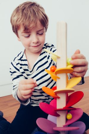 Boy playing with wooden construction pieces
