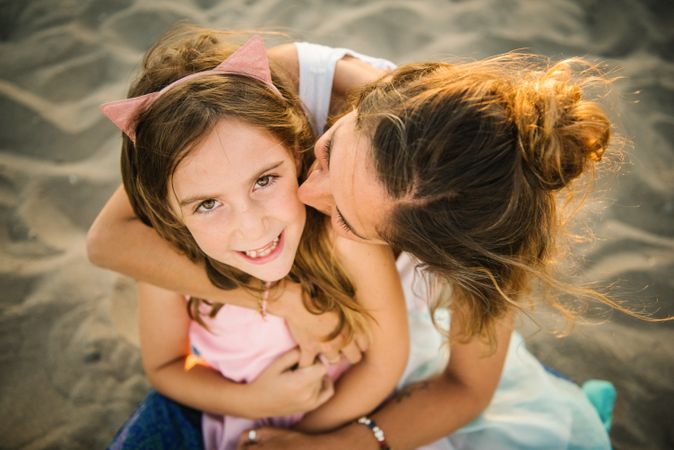 Woman with daughter on sunny beach