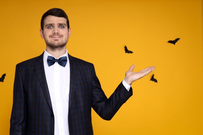 Concept of Halloween, young man on yellow background