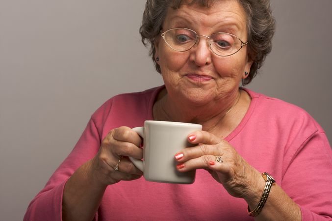 Mature Woman Enjoys Her Coffee