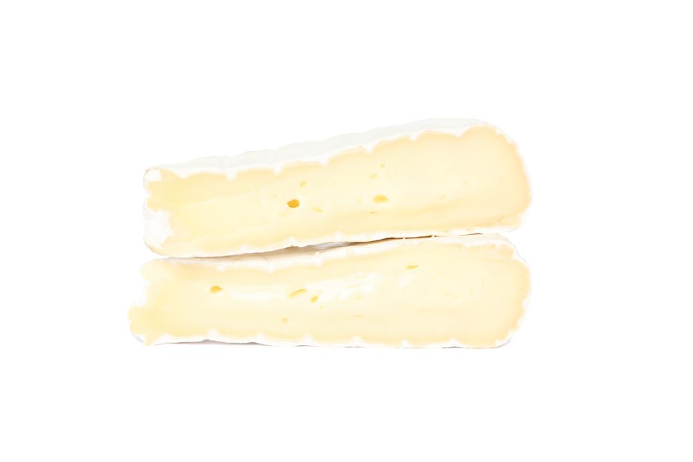 Pieces of camembert isolated on plain background