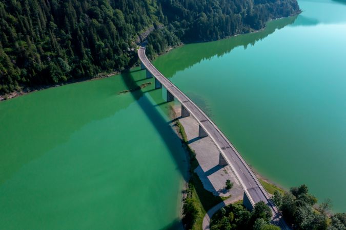 Drone shot with the bridge over Lake Sylvenstein in the bright light of summer