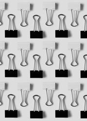 Binder clips on light background
