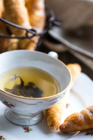 Close up of cup of tea with pastry