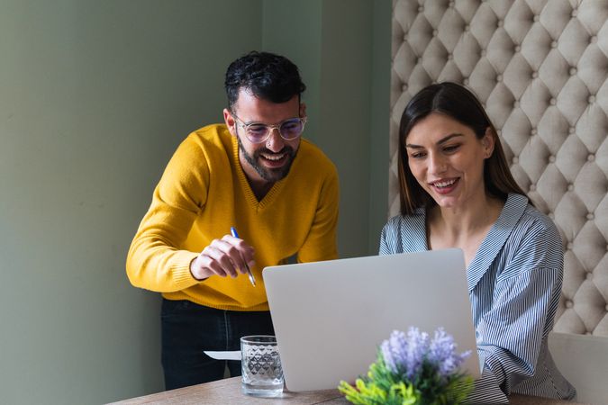 Focused colleagues working on laptops in coworking space